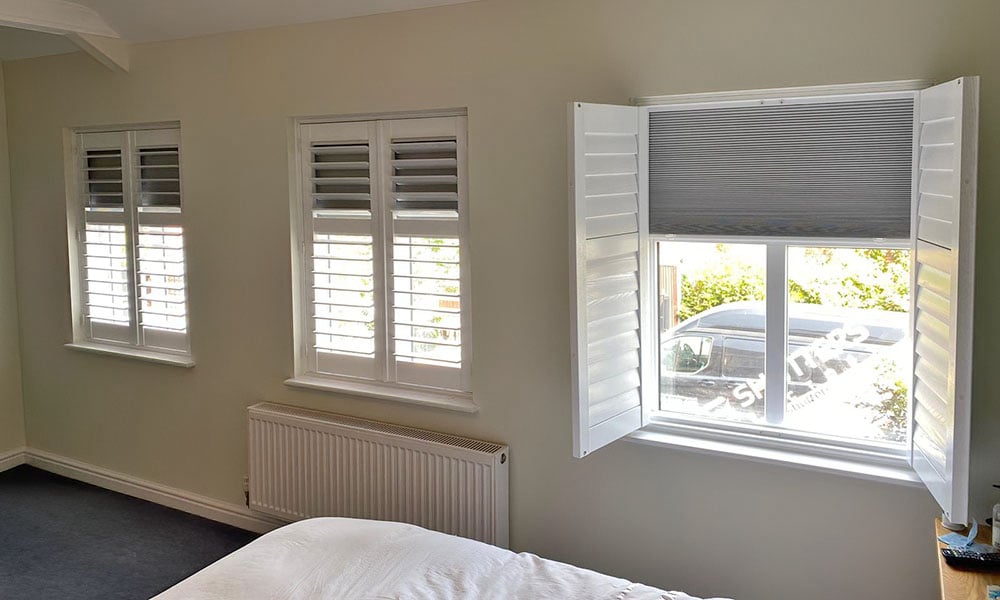 Blackout shutters with integrated blackout blind